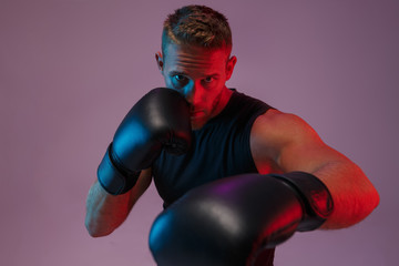 Sports man boxer make boxing exercises.