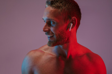 Man posing isolated listening music with earphones.