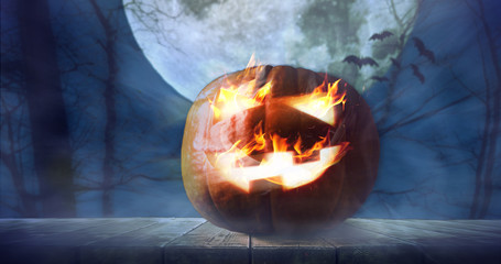Halloween pumpkin lantern in night scary autumn forest. Spooky celebration background