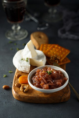 Homemade onion jam served with cheese and nuts