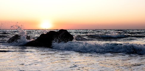 Beautiful sunset (sunrise) over the sea, beautiful waves.