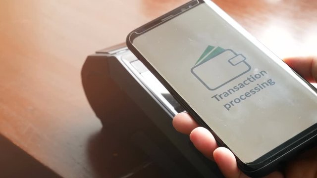 4K. contactless payment, customer paying bill through smartphone using NFC technology at point of sale terminal during shopping time. mobile digital wallet technology concept