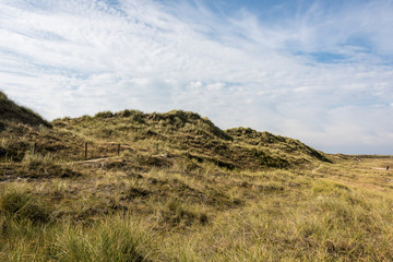 Beautiful tranquil dune landscape and long beach at North Sea