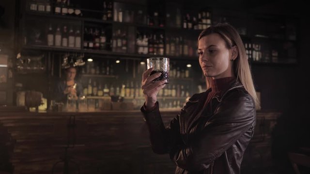 Catering, restaurant critic tastes fashionable cocktail prepared by professional bartender in popular bar, businesswoman