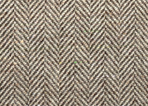 Lighte Brown woolen fabric striped zigzag. Herringbone tweed, Cashmere Background Texture. Coat close-up. Expensive men's suit fabric. High resolution