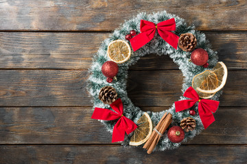 Christmas wreath on wooden background. Holiday decoration