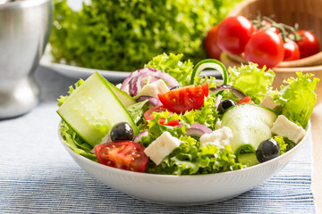 Salad with fresh vegetables olives tomatoes red onion greek cheese feta and olive oil