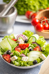 Salad with fresh vegetables olives tomatoes red onion greek cheese feta and olive oil