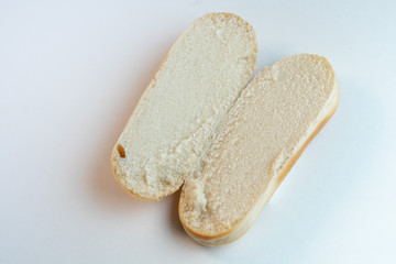 Hot dog bun or bread cut in half on a isolated white background. Top view. Close-up