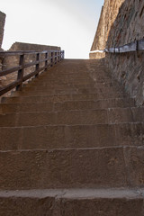 Fototapeta premium Fragment of a stone staircase leading to a closed courtyard on t