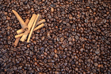 Cinnamon sticks on a background of coffee beans