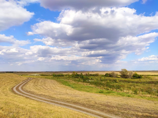 Fototapeta na wymiar Country dirt road and blue sky