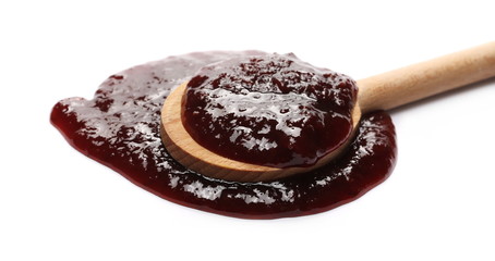 Traditional strawberry jam with wooden spoon isolated on white background