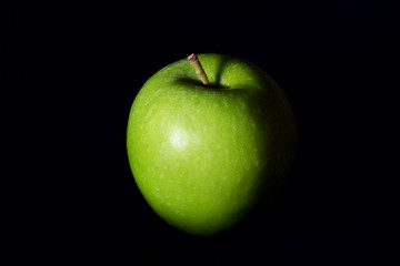 an apple on black background