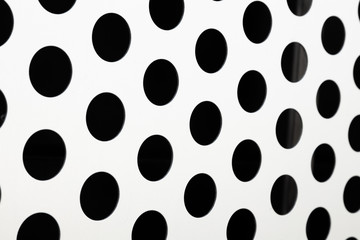 Rapid black big dot pattern on white background, round holes texture on perforated metal panel surface