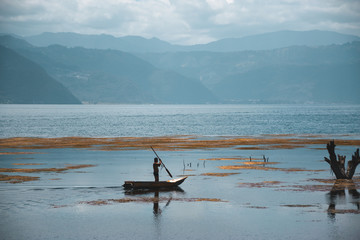 Man stood up on a boat Lake Atitlan