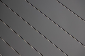 Close-up of smooth matte grey siding wall of building