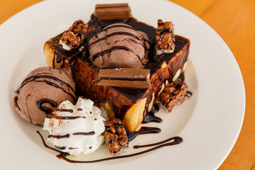 Chocolate toast with icecream, dessert menu in white dish.