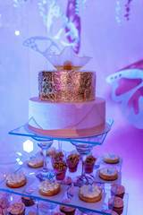 Wedding cake and candy bar. wedding cake and cupcakes