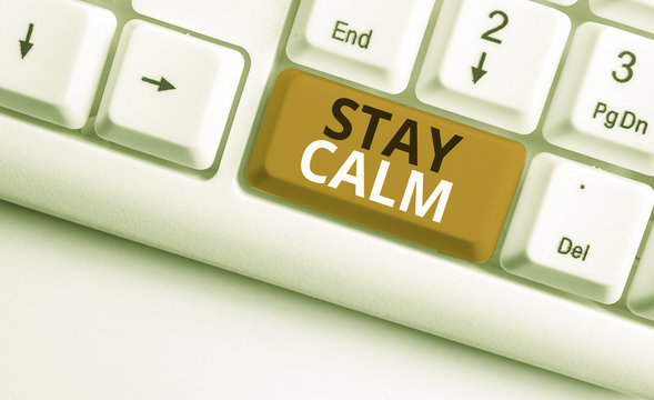 Writing note showing Stay Calm. Business concept for Maintain in a state of motion smoothly even under pressure White pc keyboard with note paper above the white background