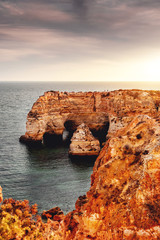 Fototapeta na wymiar Beautiful ocean seascape view of the coastal shore with soft sunset light. Praia da Marinha, Famous Beach, Algarve Coast in South Portugal, Atlantic Ocean