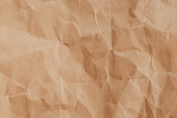 Crumpled brown paper background, textured effect. Messy wrinkled parchment. Wrapping paper, craft sheet, old card.