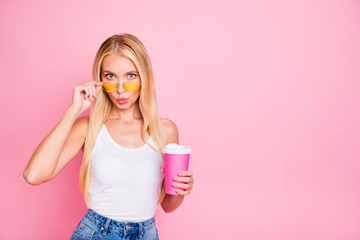Photo of pretty lady holding hot beverage takeout container wear sun specs and casual outfit isolated pink color background