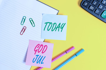 Text sign showing God Jul. Business photo showcasing Merry Christmas Greeting showing for new year happy holidays Empty blue paper with copy space paper clips and pencils on the yellow table