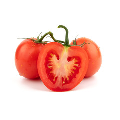 Red tomato in a cut and whole. Isolated on a white background.