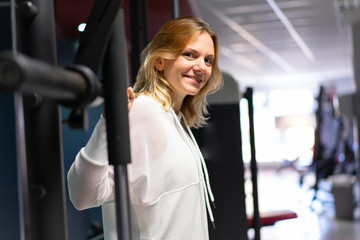 Sport Woman in a gym making weightlifting
