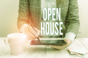 Fototapeta na wymiar Writing note showing Open House. Business concept for you can come whatever whenever want Make yourself at home Business woman sitting with mobile phone and cup of coffee on the table