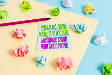 Handwriting text Dream Big Work Hard Stay Focused. Conceptual photo Dream Big Work Hard Stay Focused And Surround Yourself With Good People Colored crumpled papers empty reminder blue yellow