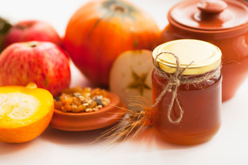 Fresh sliced pumpkin(squash), apples, glass jar of honey isolated on white background. Food, Thanksgiving day concept. Top view. Space for a text. Flat lay. Close up.