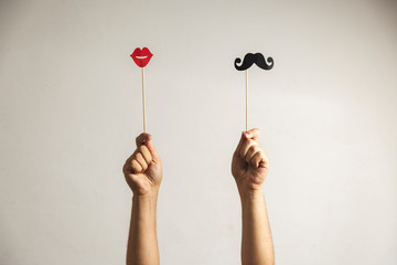 Hands holding up Photo booth props lips and Black Mustache