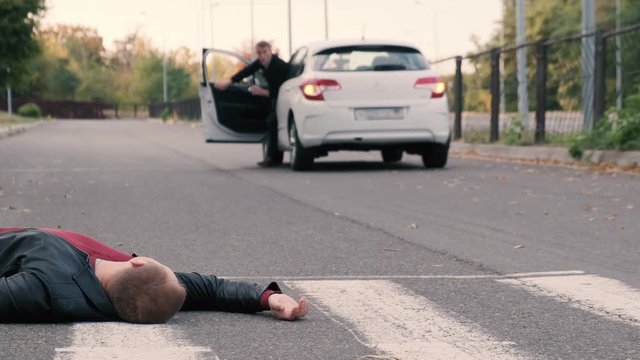 Hit a pedestrian. A pedestrian injured in an accident lying on the pavement