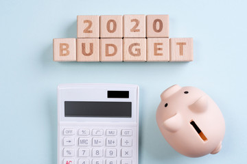 Abstract 2020 financial goal design concept - geometric wood blocks cubes on blue table background...