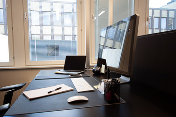 Luxury office desk with paper and pen. Laptop with external screen.