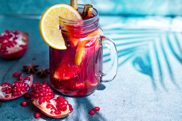 Hot drink. vitamin soft pomegranate drink for health with cinnamons spices, anise star and orange. concept of vitamin drink for winter menu. hot drink for winter. bright sunlight. copy space