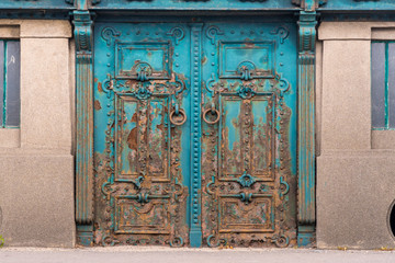 Vintage rusty Entrance door undar platform decorated with wrought iron. Object.