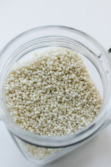 Raw white chia seeds in jar , macro