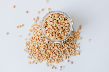 Glass jar with raw dry peas, macro