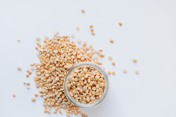 Glass jar with raw dry peas, macro