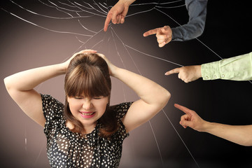 woman covered her head in despair with her hands, many people accuse her of her fingers accusing...