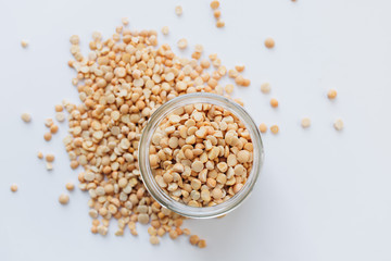 Glass jar with raw dry peas, macro