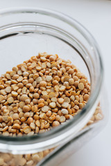 Glass jar with raw dry peas, macro