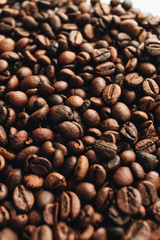 Close-up view of roasted coffee beans and glass cup