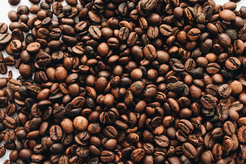 Close-up view of roasted coffee beans and glass cup