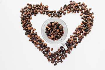 Close-up view of roasted coffee beans, pile in shape of heart 