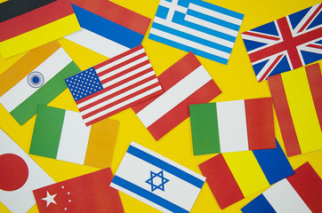 Fototapeta na wymiar Flags of different countries on yellow background