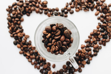 Close-up view of roasted coffee beans, pile in shape of heart 